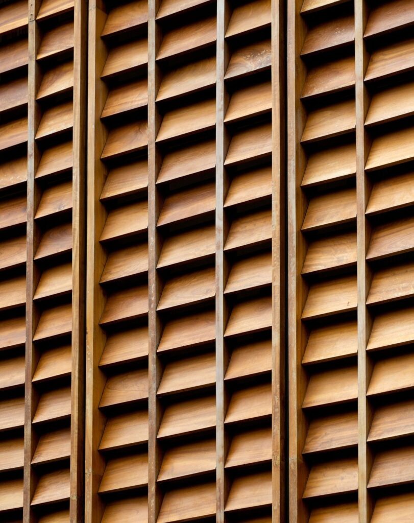 Wooden shutters on a building, acting as a facade screen.