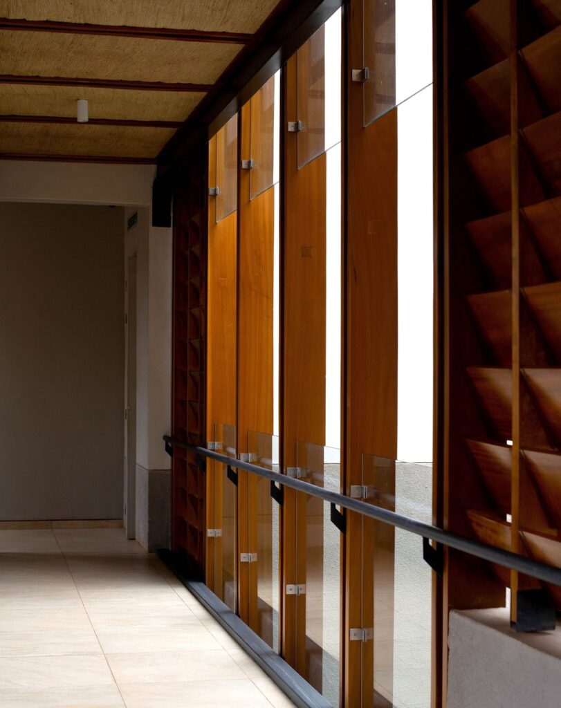 A hallway with wooden panels and glass, providing a warm and inviting atmosphere.