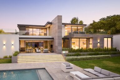 A contemporary house with a pool and outdoor seating area, perfect for relaxation and entertainment.