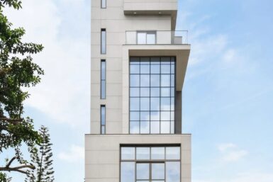 Mixed-use tower in Nigeria with a cladded exterior and glass facade treatment.