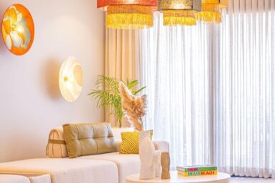 White living room with colourful lighting and decor.