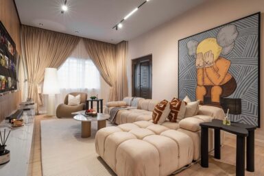 Living room in nigeria with a neutral colour palette and a big wall art.