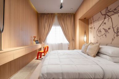 Bedroom featuring a forest-inspired wall paper within a wooden framed nook and two pendant bedside lights.