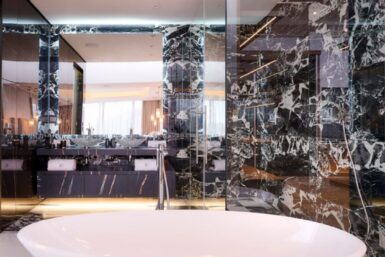 Frameless glass shower screen highlighted in luxe bathroom