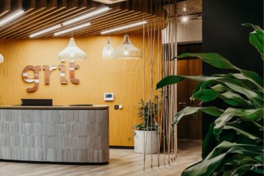 Reception area in Grit head office with afro-inspired theme and exposed ceiling.