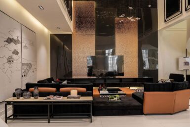 Luxury TV wall with reflective panels in living room interior by Serdamol Interiors.