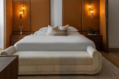 Elaborate headboard with bedside table in minimal bedroom.