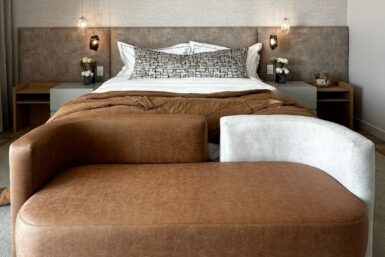 Chic bedroom in South Africa with modern extended headboard and comfy bedend
