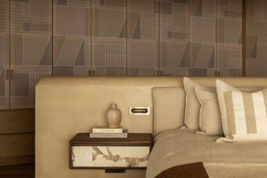 Bed with elaborate headboard and floating nightstand with marble patterned face.