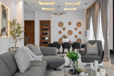 White and Grey living room with wooden accents and indoor planting.