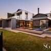 Modern house design in South Africa featuring sleek lines, large windows, and a blend of natural materials.