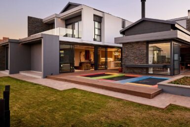 Modern house design in South Africa featuring sleek lines, large windows, and a blend of natural materials.