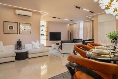 LIving room with textured wall and white sofas.